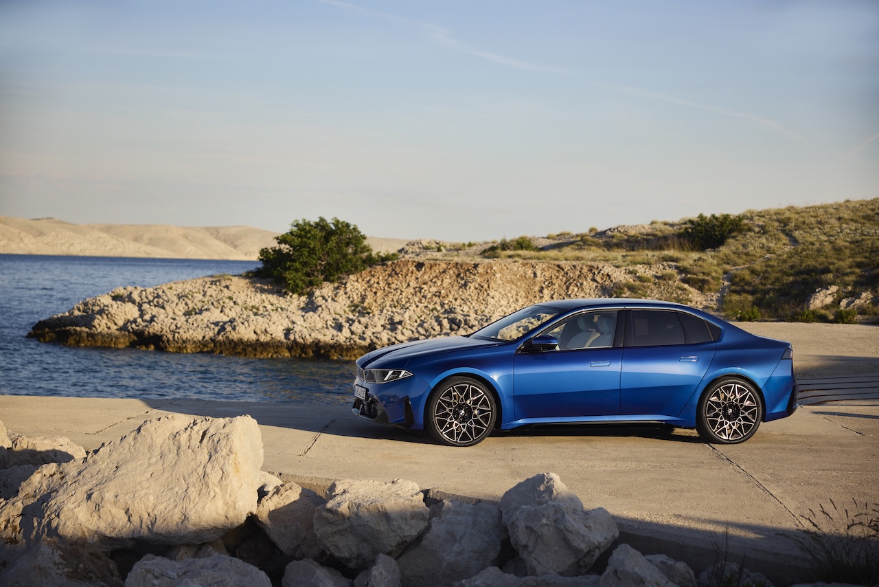 Blue BMW i3 Sedan exterior side view showing its elongated sports sedan profile