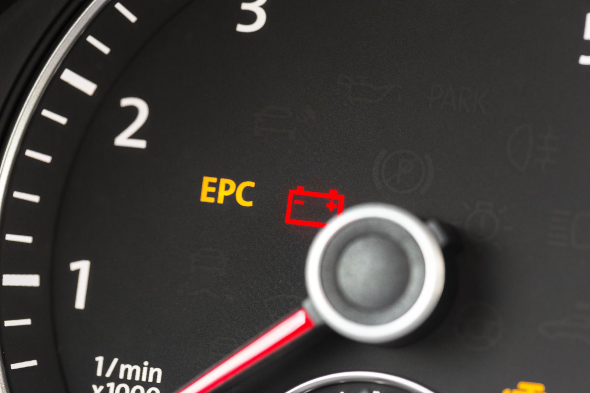 Volkswagen service technician inspecting a vehicle for EPC warning light concerns at Volkswagen of Naples Service Center