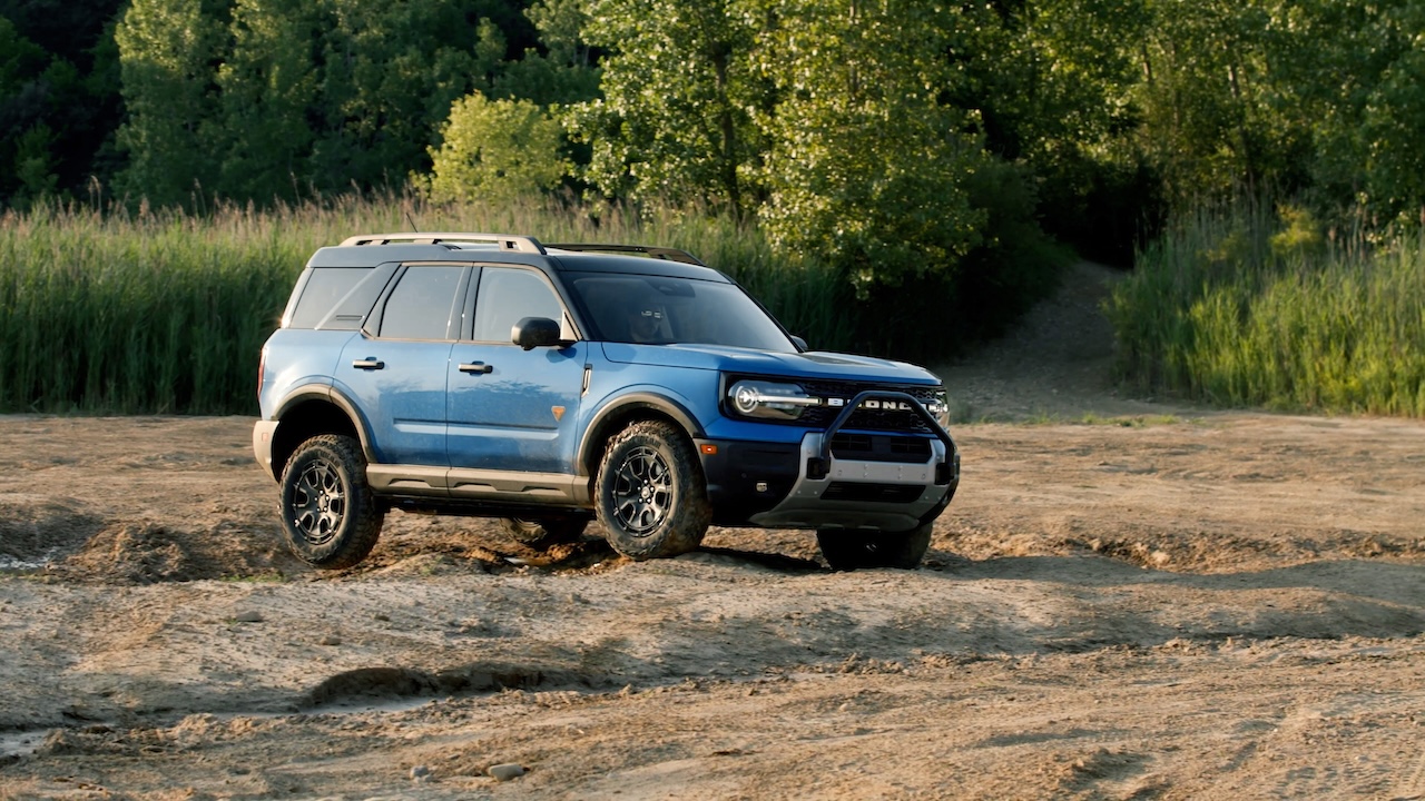 Ford Bronco Sport driving on a wooded dirt trail for Blue Ridge drivers comparing Ford dealership options at Athens Ford