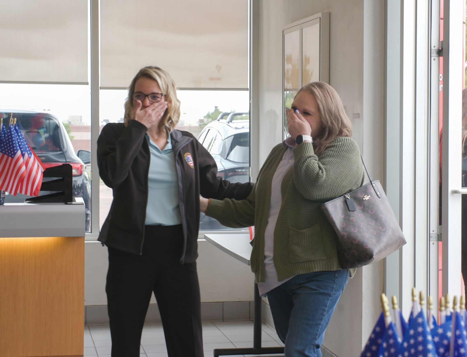 Joanna Harris and a Military Warriors Support Foundation representative share an emotional moment at the surprise ceremony