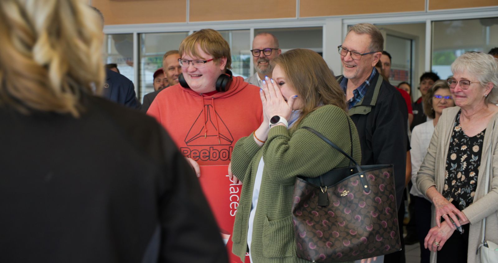 Joanna Harris and her son react with joy and disbelief during the vehicle surprise ceremony at South Colorado Springs Nissan