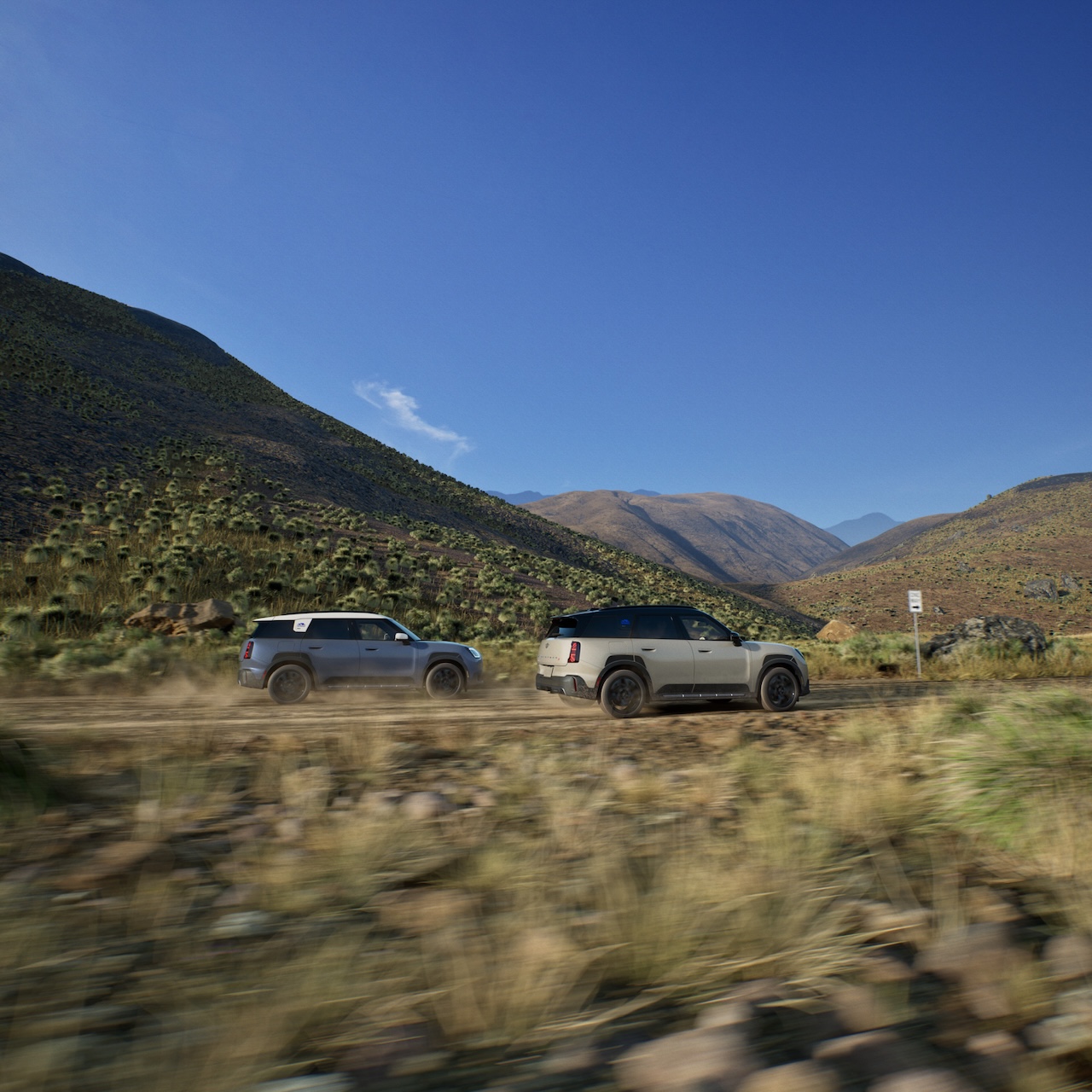 Two 2026 MINI Countryman Untamed Edition vehicles navigating rugged off-road terrain showcasing MINI Intelligent All-Wheel Drive system
