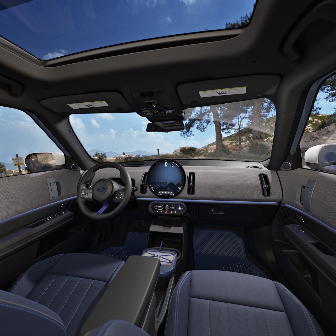 Interior of the 2026 MINI Countryman Untamed Edition showing JCW Sport Seats in Nightshade Blue with rock-inspired knit upholstery and Cornflower Blue steering wheel strap